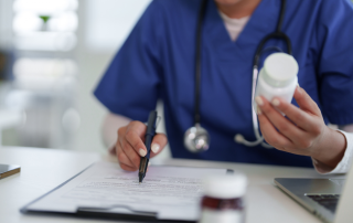 Hospice nurse reviewing medications with a family caregiver at home