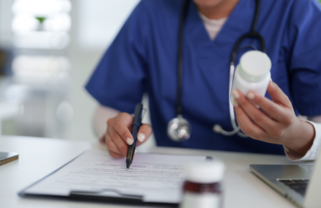 Hospice nurse reviewing medications with a family caregiver at home