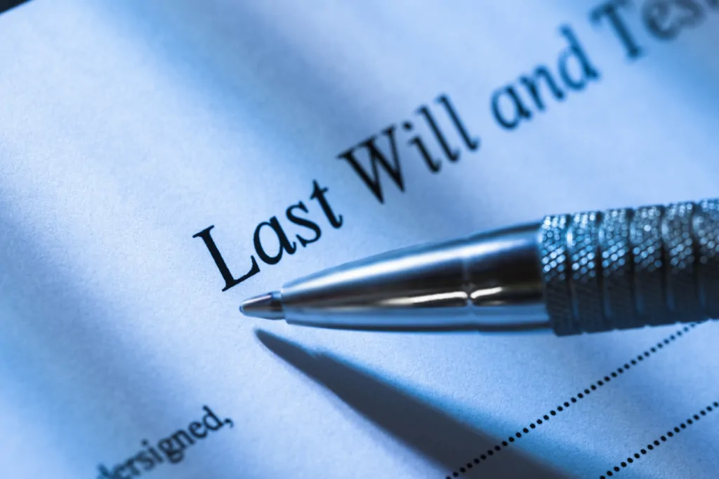 Pen resting on a Last Will and Testament document
